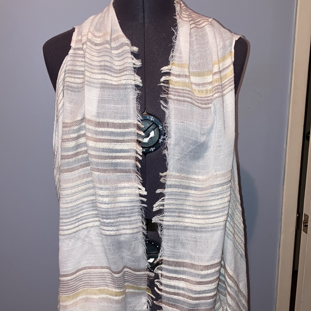 Sleeveless light wrap in pastel blues and yellows. One size. No tags.
